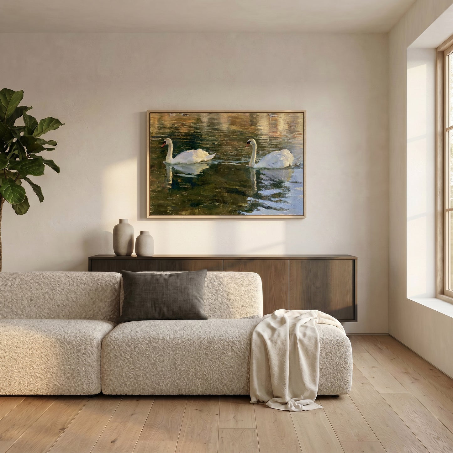 a serene living room with a large painting of two swans swimming in a pond hanging on the wall above a beige sofa.