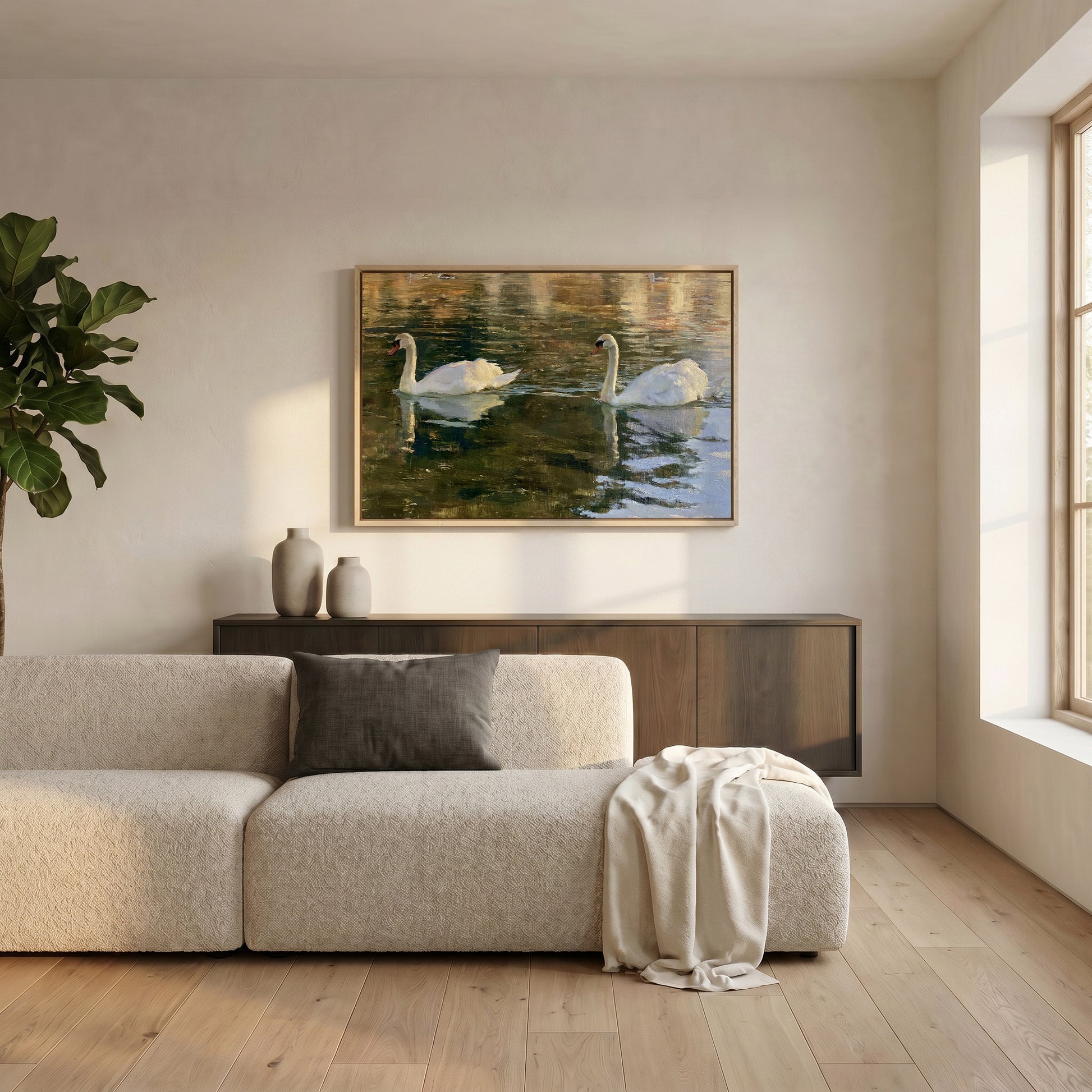 a serene living room with a large painting of two swans swimming in a pond hanging on the wall above a beige sofa.