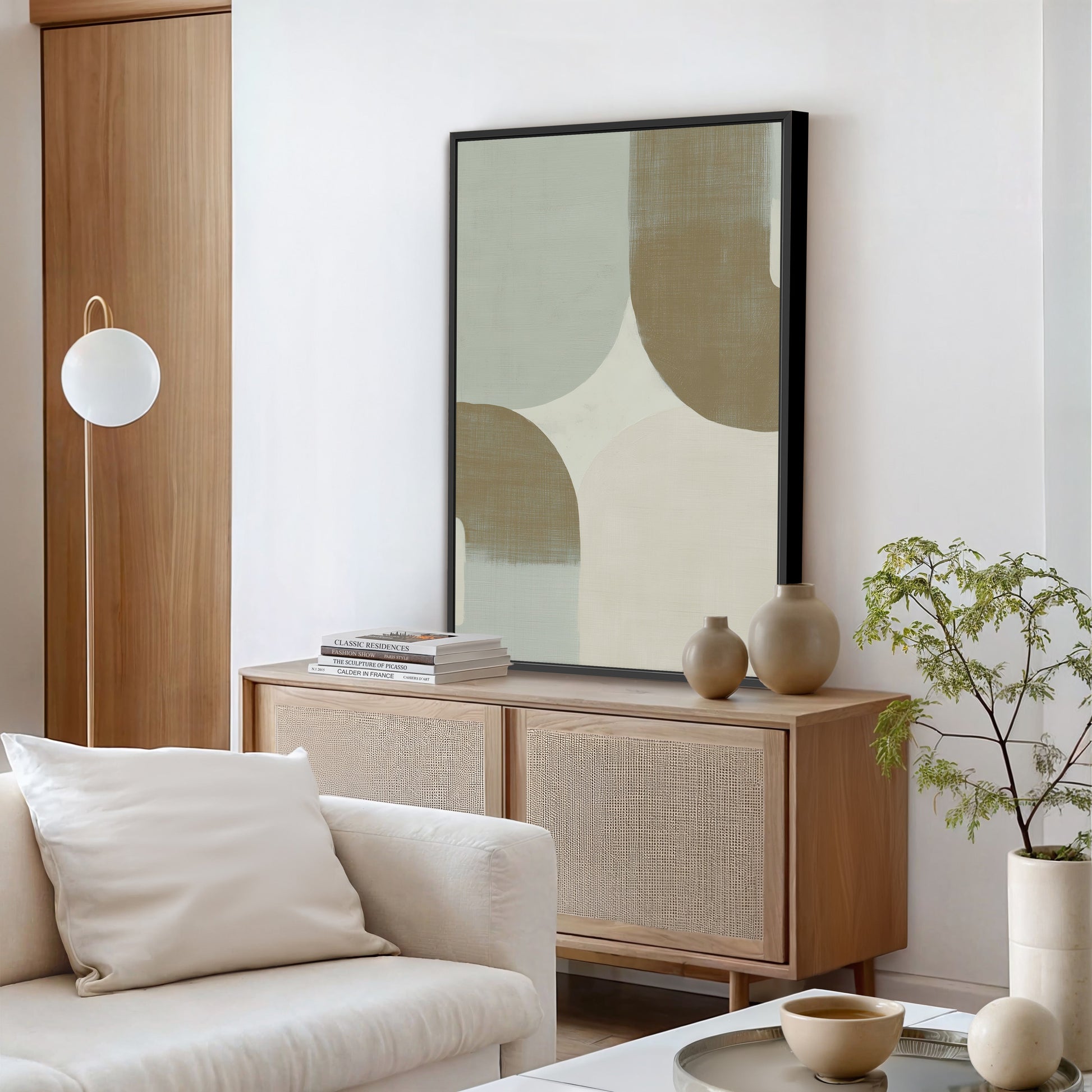 Forma Canvas Art featuring muted sage, ivory, and taupe geometric shapes in a black frame displayed in a modern minimalist living room.