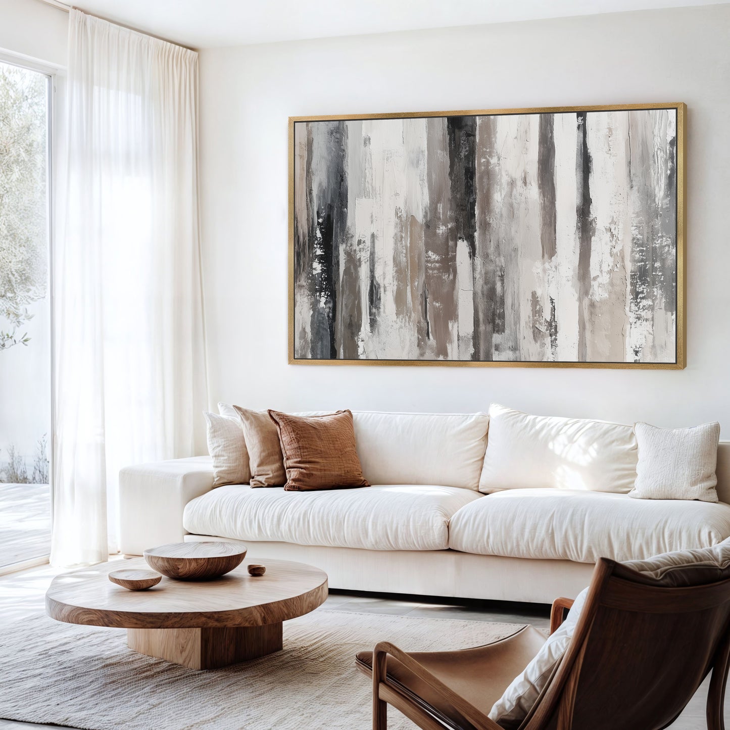 a modern living room with a large abstract painting on the wall, a white sofa, a wooden coffee table, and a brown leather armchair.
