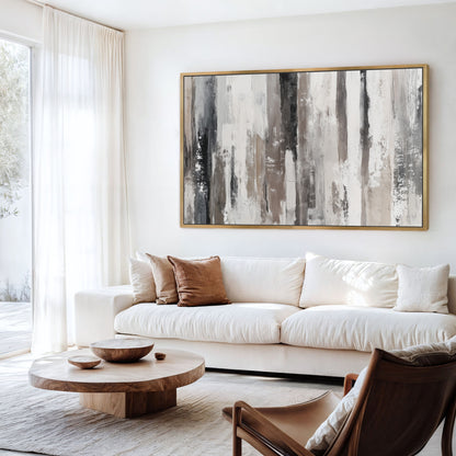 a modern living room with a large abstract painting on the wall, a white sofa, a wooden coffee table, and a brown leather armchair.