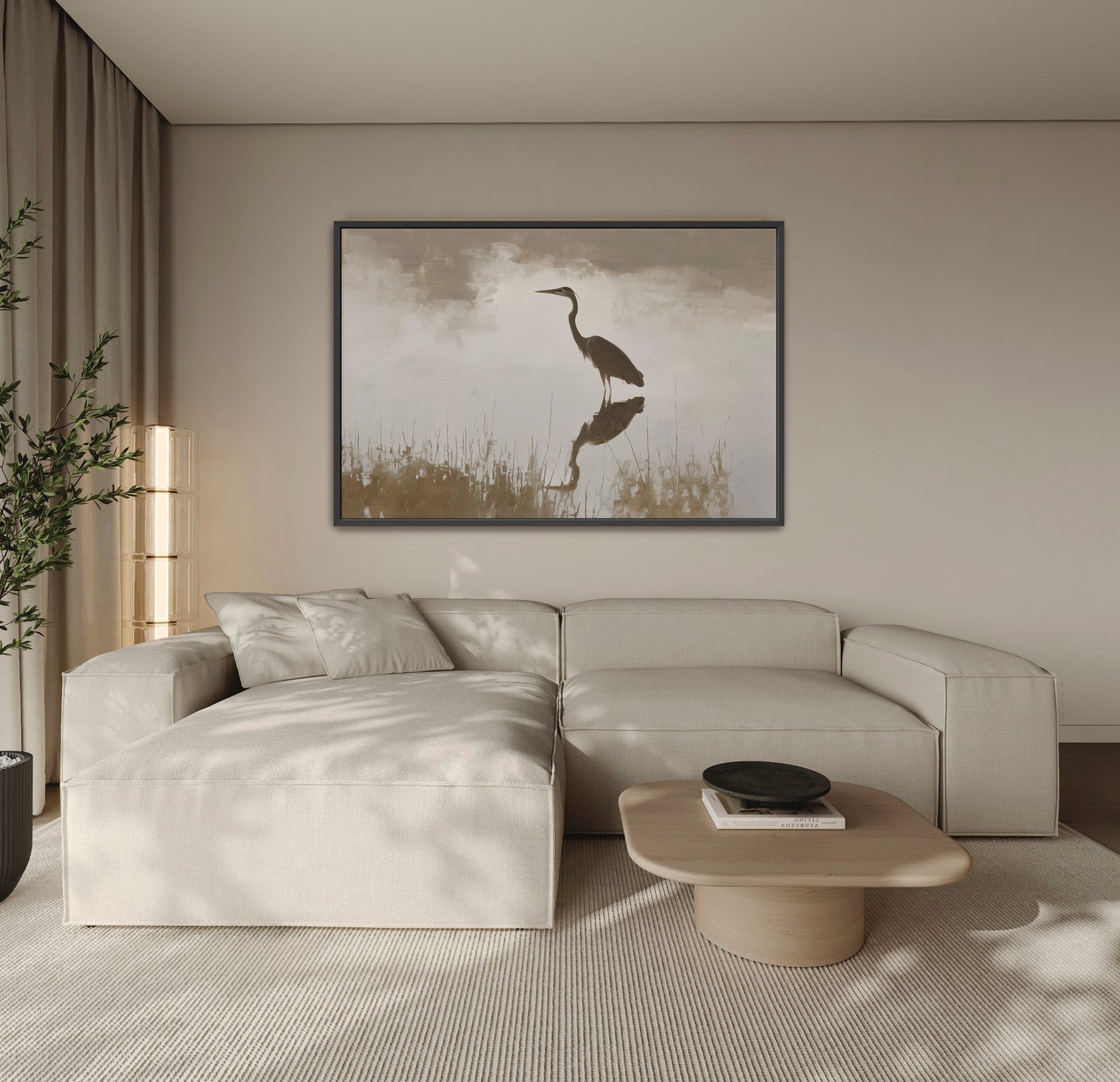 Wade Canvas Print of a heron reflected in calm water with muted earth tones hanging above a beige sectional sofa in a modern living room