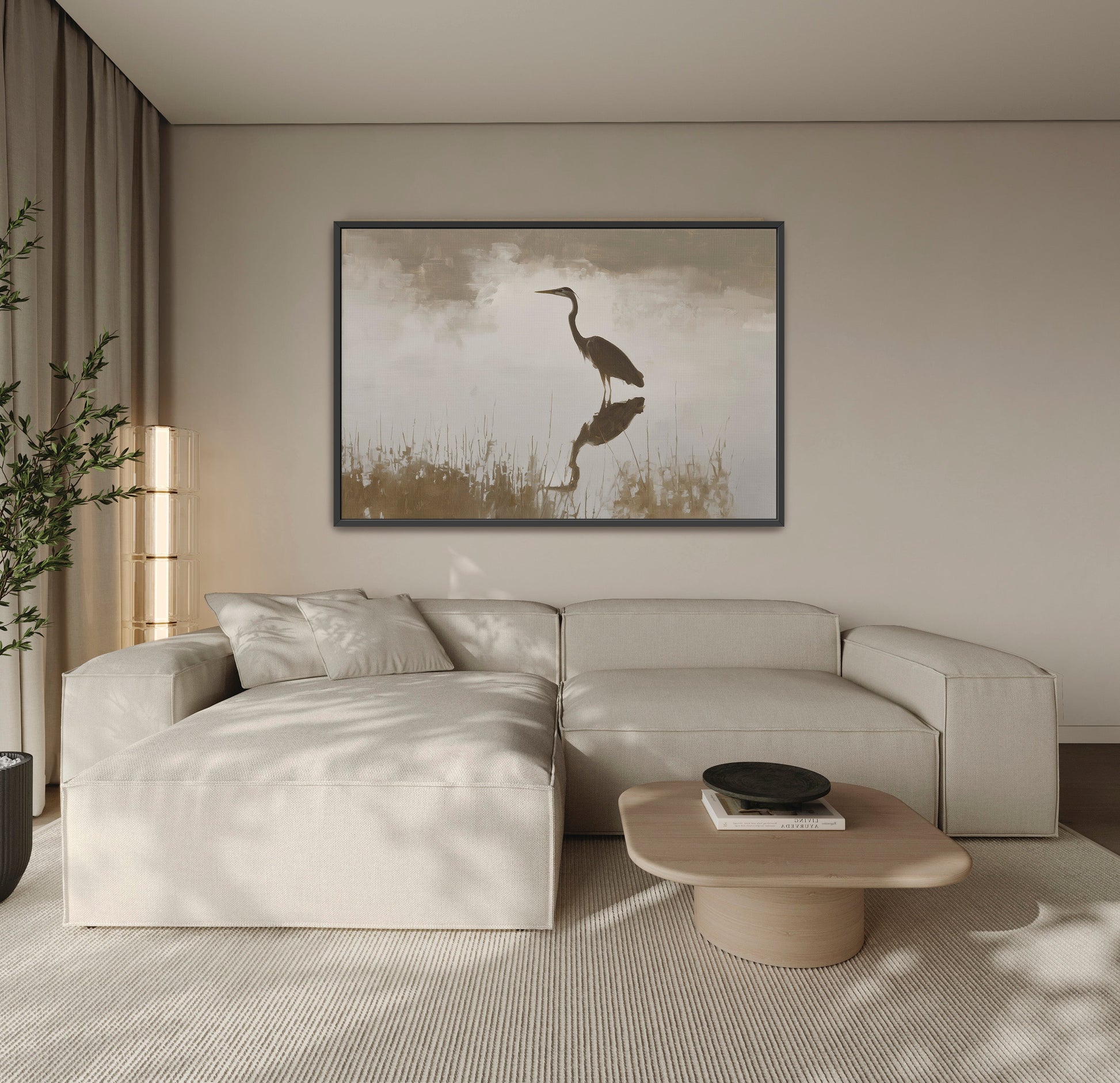 Wade Canvas Print of a heron reflected in calm water with muted earth tones hanging above a beige sectional sofa in a modern living room