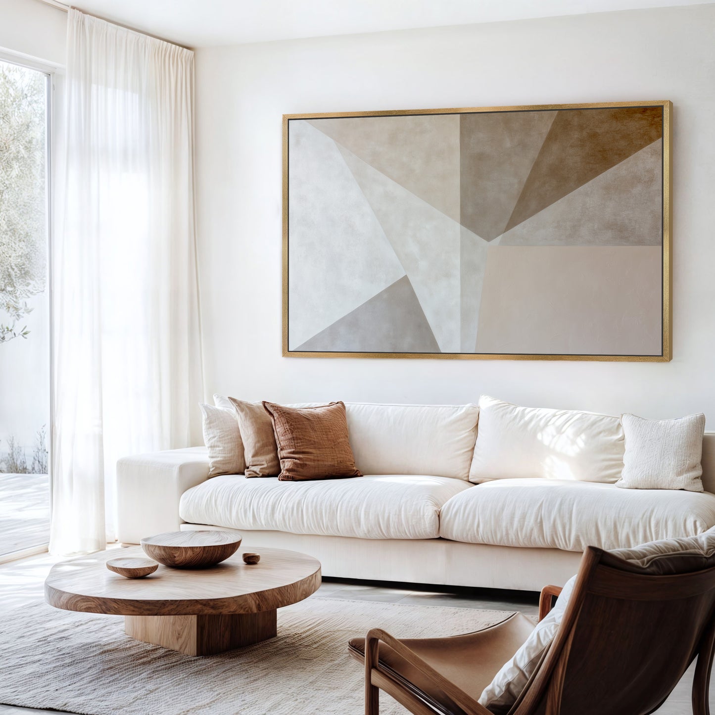 a modern living room with a large abstract painting on the wall, a white sofa, a wooden coffee table, and a brown leather armchair.