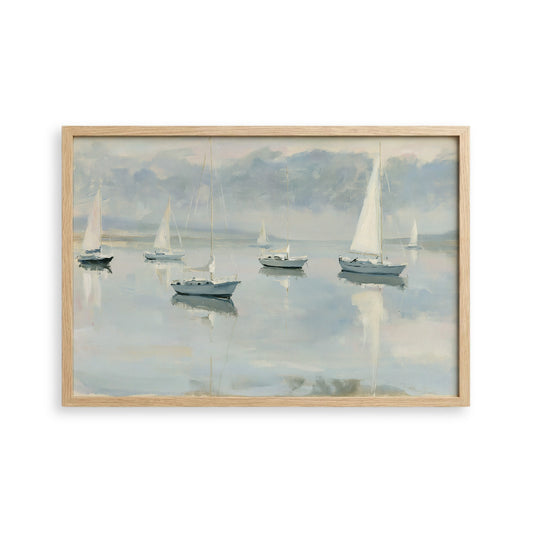 a serene scene of sailboats gently floating on a calm body of water, with a cloudy sky in the background.