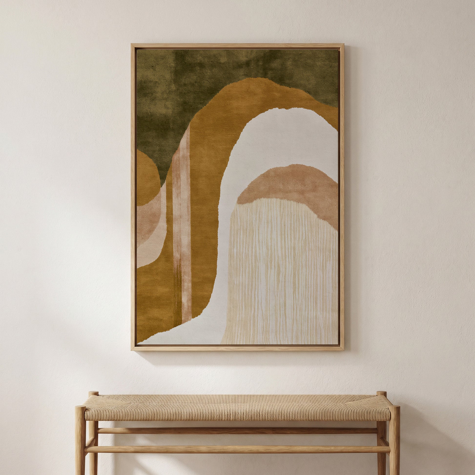 a large abstract painting hanging on a wall above a wooden bench.