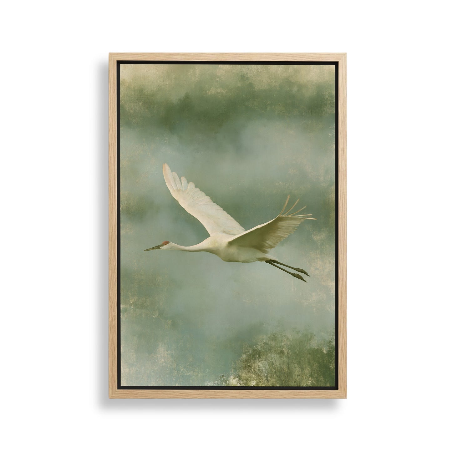 A white crane with outstretched wings is captured in flight against a backdrop of a cloudy sky.