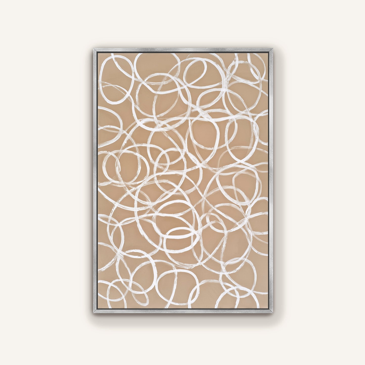 a square frame with a beige background and white, abstract swirls or circles on it.