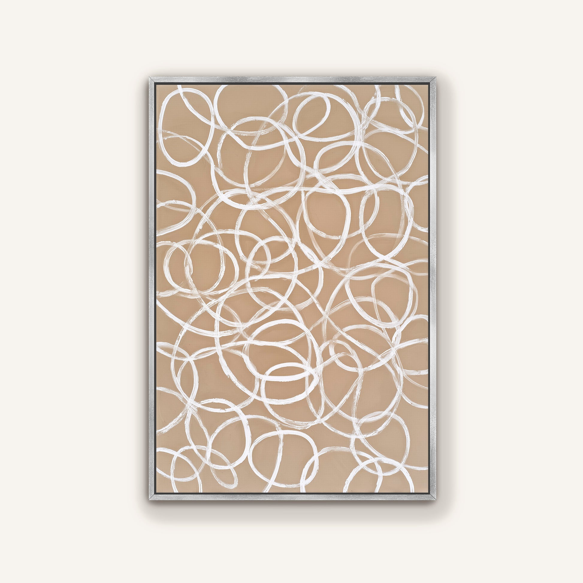 a square frame with a beige background and white, abstract swirls or circles on it.