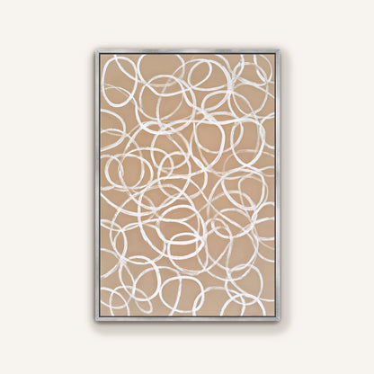 a square frame with a beige background and white, abstract swirls or circles on it.