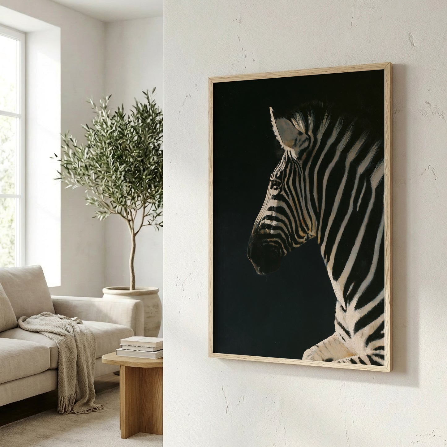 a zebra in profile, with its distinctive black and white stripes, against a dark background. The zebra is the central focus of the image, which is framed and hung on a wall in a living room setting.