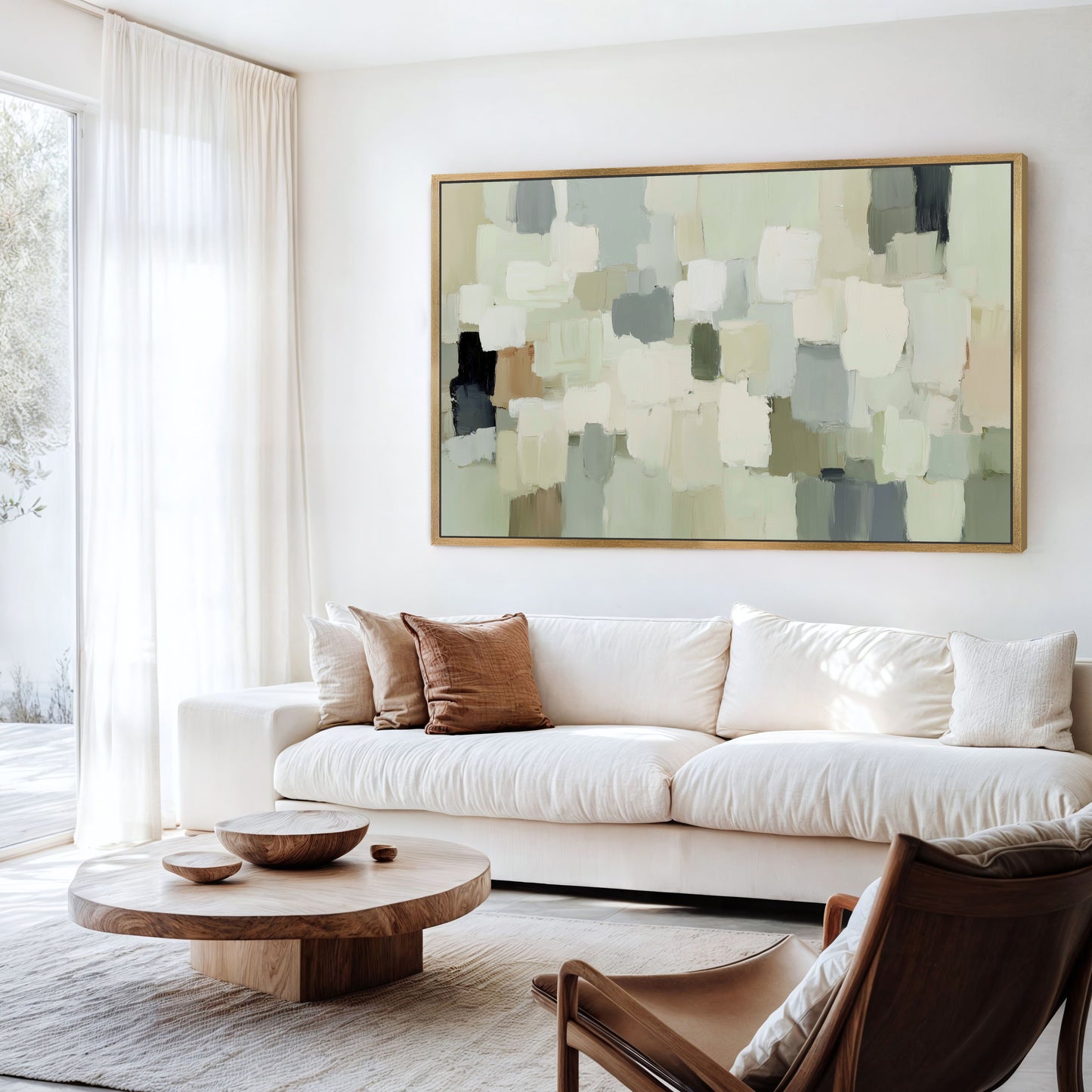 a modern living room with a large abstract painting on the wall above a white sofa. The room has a wooden coffee table in front of the sofa, and a brown leather armchair is situated nearby. The overall decor has a minimalist and contemporary style.