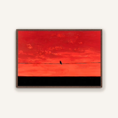 A lone bird perched on a wire against a vibrant red and orange sky.