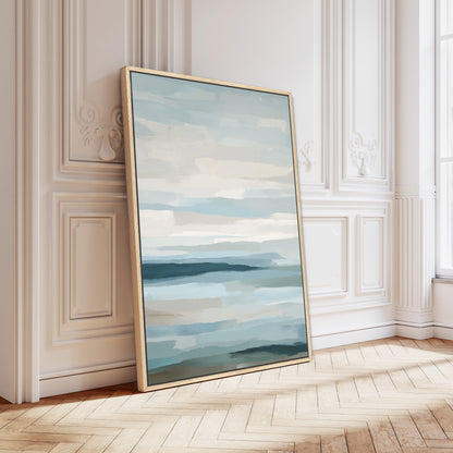 Lapse canvas print depicting serene sea and sky with soft blue, ivory, and sand tones in a natural wood frame.