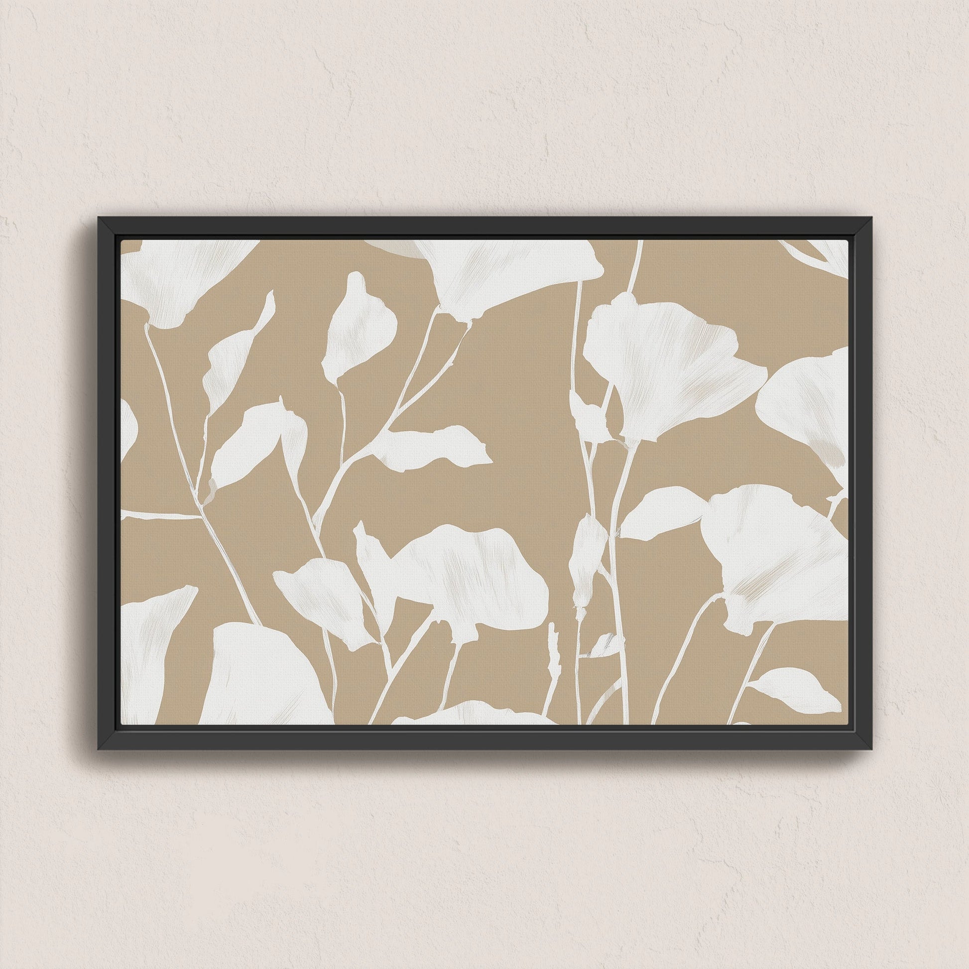 Driftleaf canvas print with white floral silhouettes on beige background in black frame