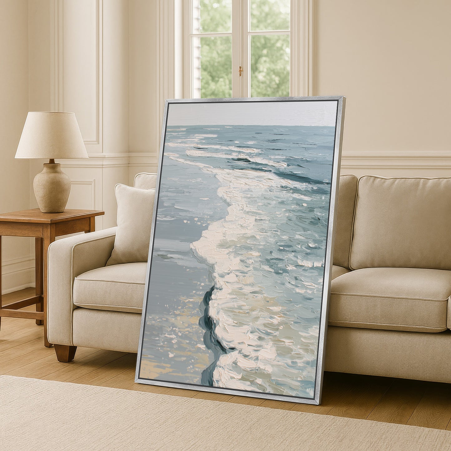 a large framed painting of a seascape, with a view of the ocean and waves, placed in a living room setting.