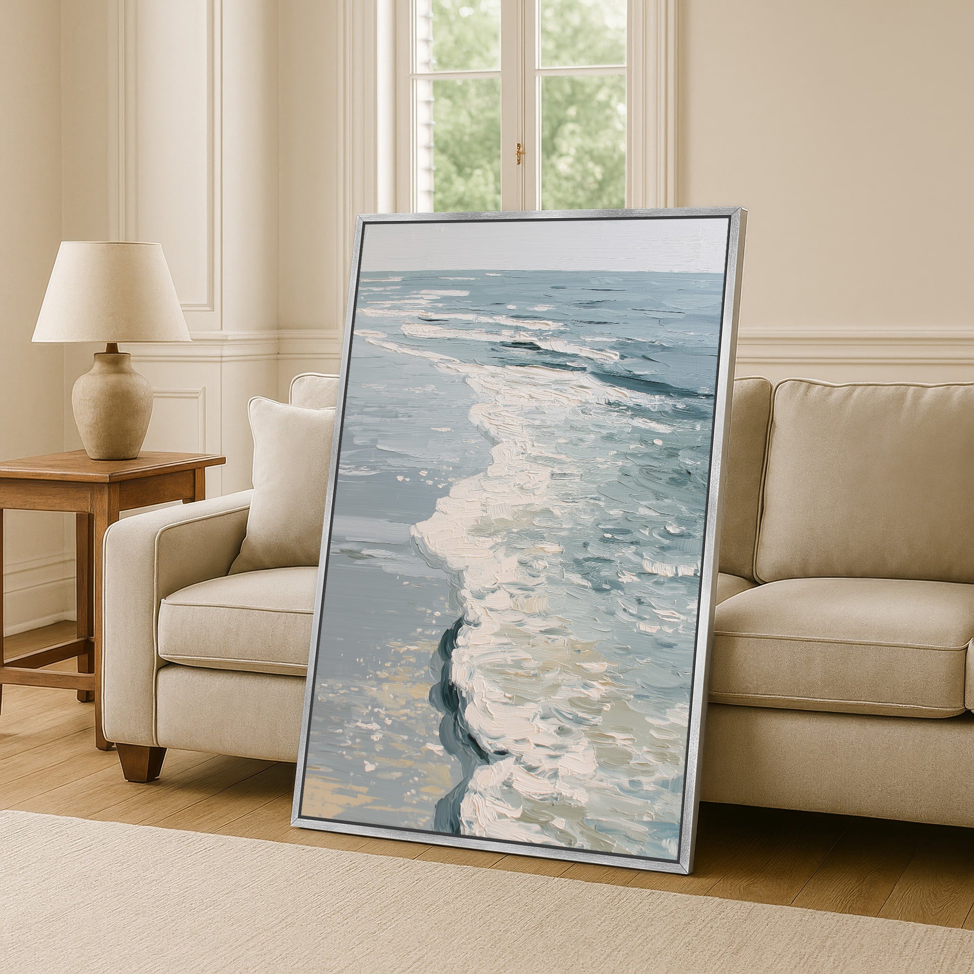 a large framed painting of a seascape, with a view of the ocean and waves, placed in a living room setting.