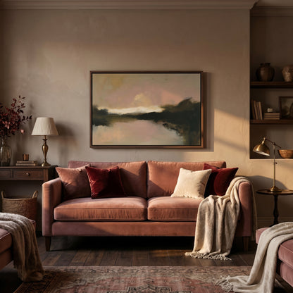 A cozy living room with a large pink sofa, a framed landscape painting on the wall, and various decorative elements such as a vase, a lamp, and a rug.