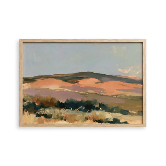 The image is a framed landscape painting depicting a desert scene with mountains in the background.