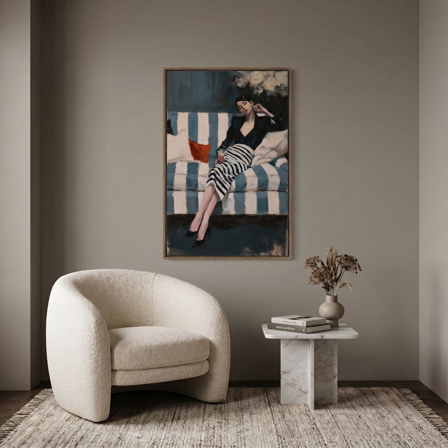a modern living room with a large painting of a woman in a striped dress hanging on the wall above a white armchair. The room also includes a small side table with a vase of flowers and a stack of books.