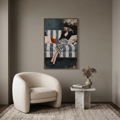 a modern living room with a large painting of a woman in a striped dress hanging on the wall above a white armchair. The room also includes a small side table with a vase of flowers and a stack of books.