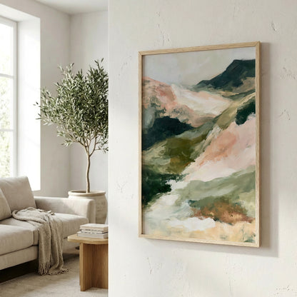 a living room with a large abstract painting hanging on the wall, a sofa, a potted plant, and a wooden side table.
