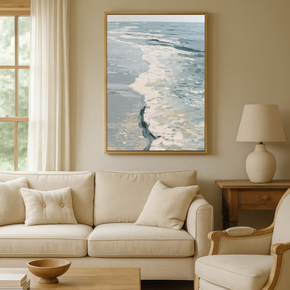 a cozy living room with a large window overlooking the ocean, a framed painting of the ocean waves hanging on the wall, a beige sofa, a wooden coffee table, and a matching beige armchair.