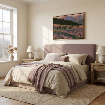 a serene bedroom with a large bed, a painting of deer in a field, and a window overlooking a scenic landscape.
