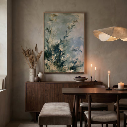 a cozy dining room with a wooden table and chairs, a large painting on the wall, and a chandelier hanging above the table.