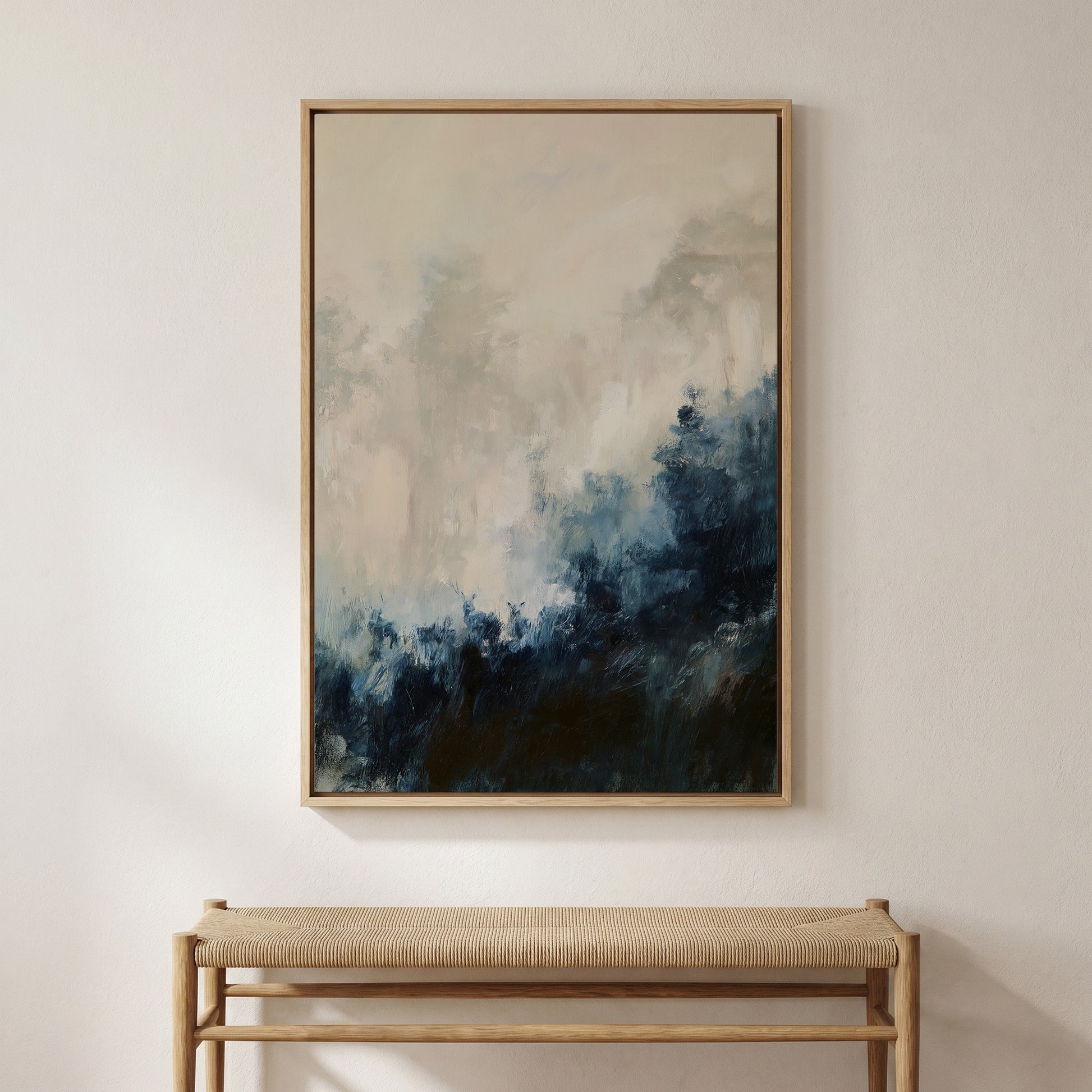 a large abstract painting hanging on a white wall above a wooden bench.