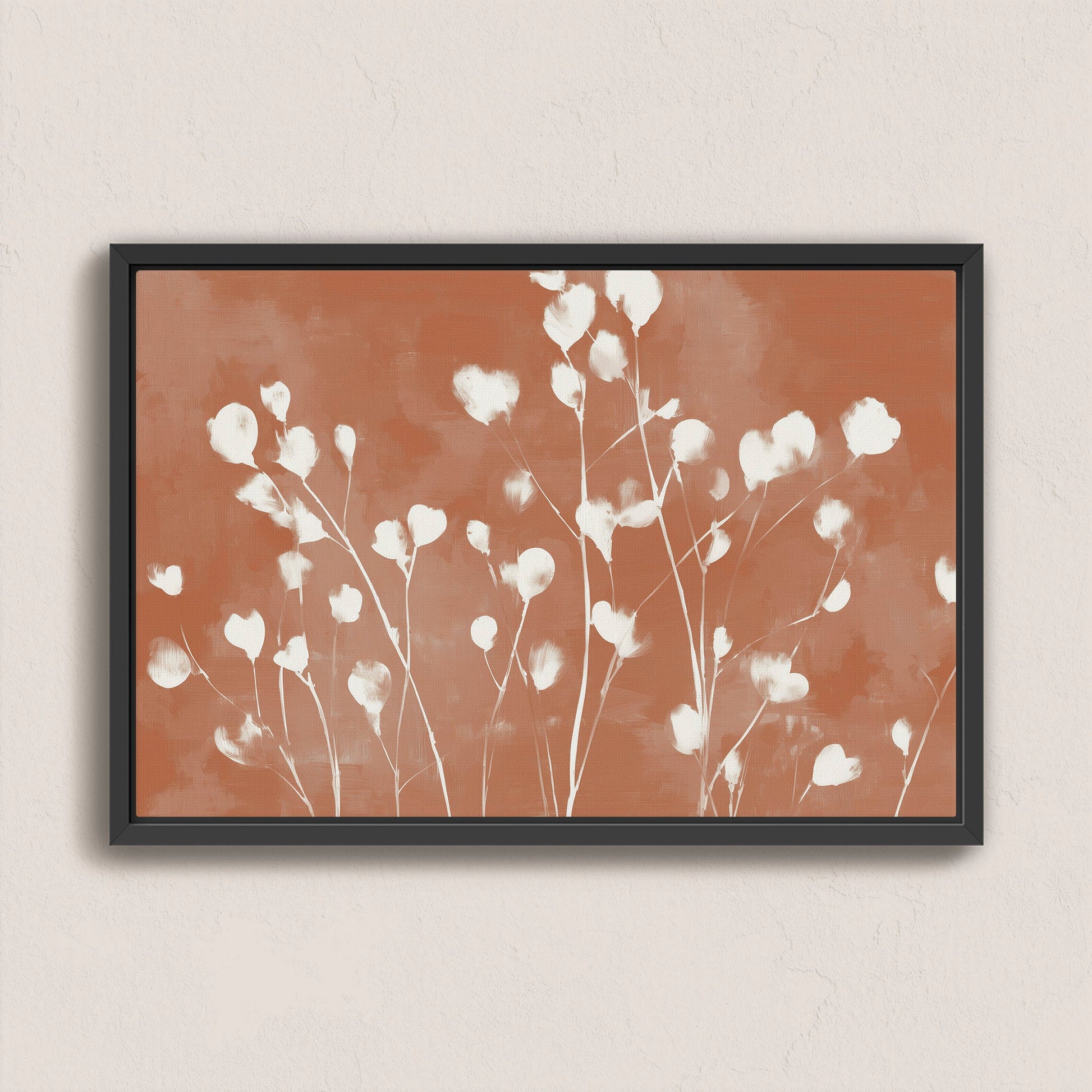 Ember canvas print with white floral design on terracotta background in black frame