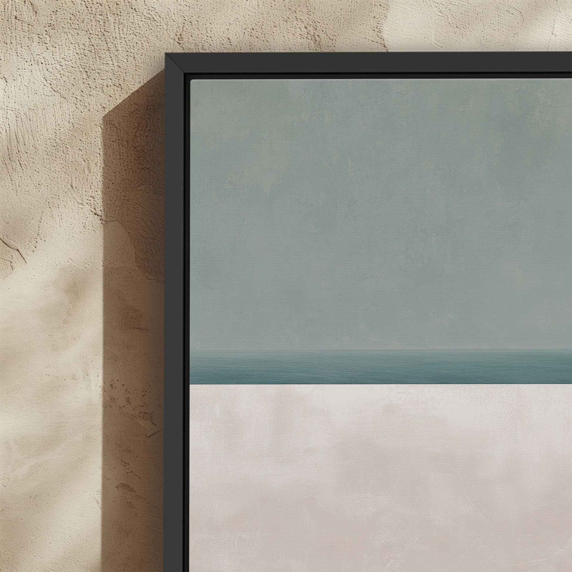 Minimalist Azure canvas print with muted sage and sand hues in a black frame on textured wall