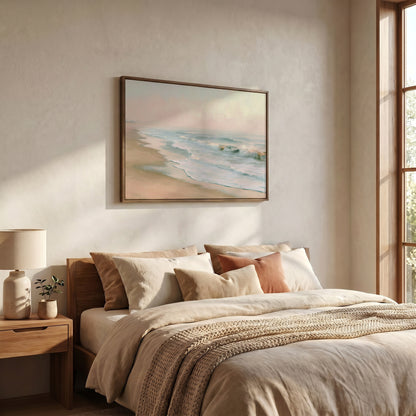 a serene bedroom scene with a large bed adorned with beige bedding and a framed painting of a beach scene hanging above it.