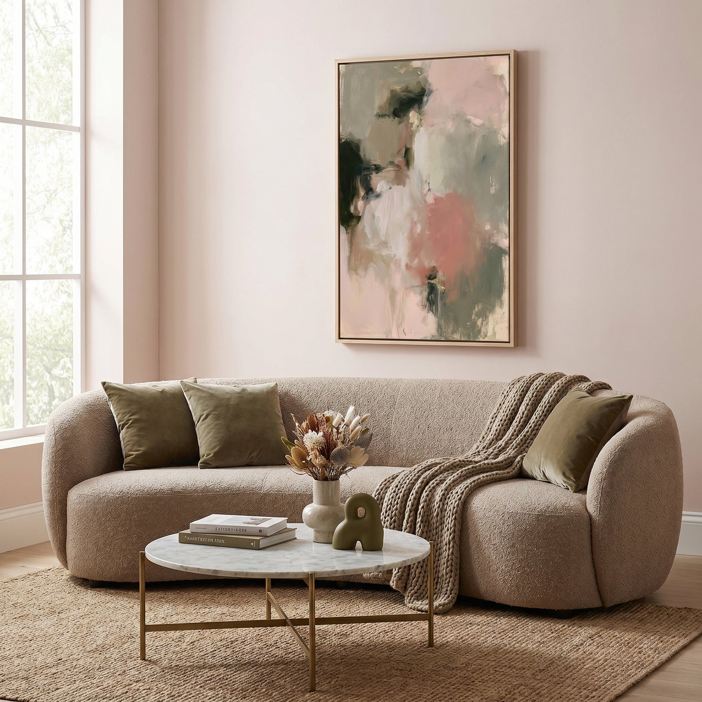 a cozy living room with a beige sofa, a round coffee table, and a large abstract painting on the wall.