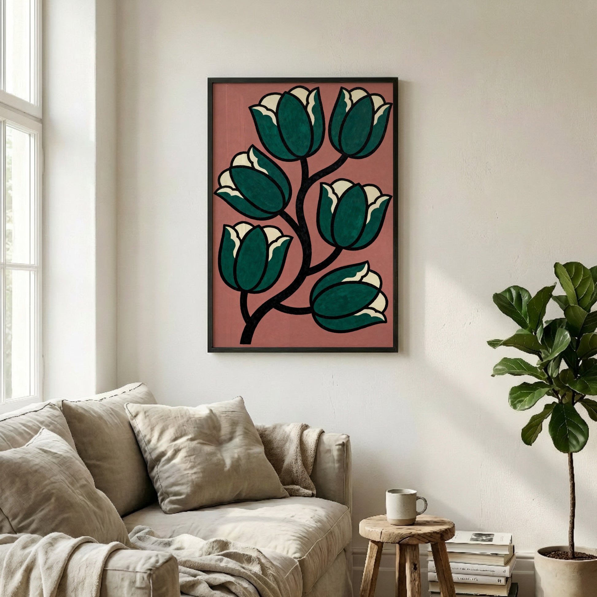 a living room with a large framed artwork of a stylized floral design hanging on the wall above a beige sofa. The artwork is framed in black and has a vibrant pink background. The room also includes a potted plant, a coffee table, and some books, creating a cozy and inviting atmosphere.
