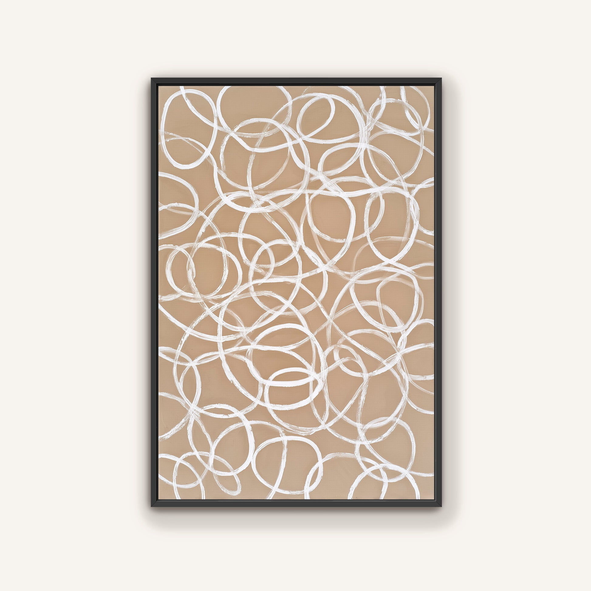 a framed abstract artwork with a repeating pattern of white circles on a beige background.