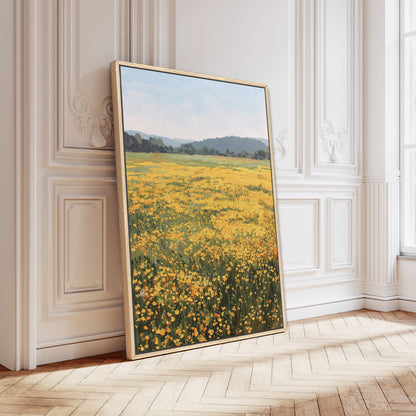 A large framed painting depicting a field of yellow flowers is leaning against a white wall in a room with a wooden floor.