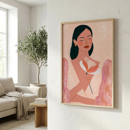a framed illustration of a woman holding a flower, hanging on a wall in a living room setting.