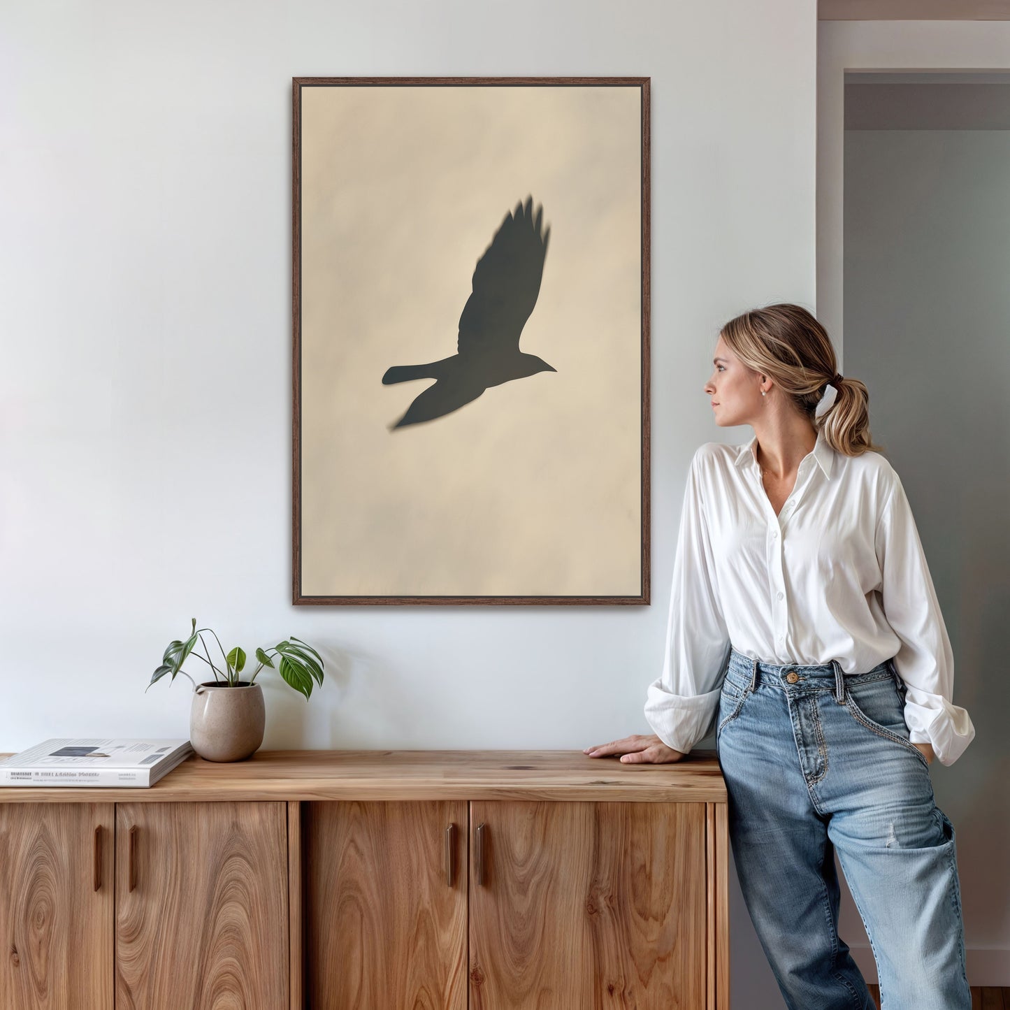Soar canvas print featuring bird silhouette in soft neutral tones, framed and displayed in modern interior