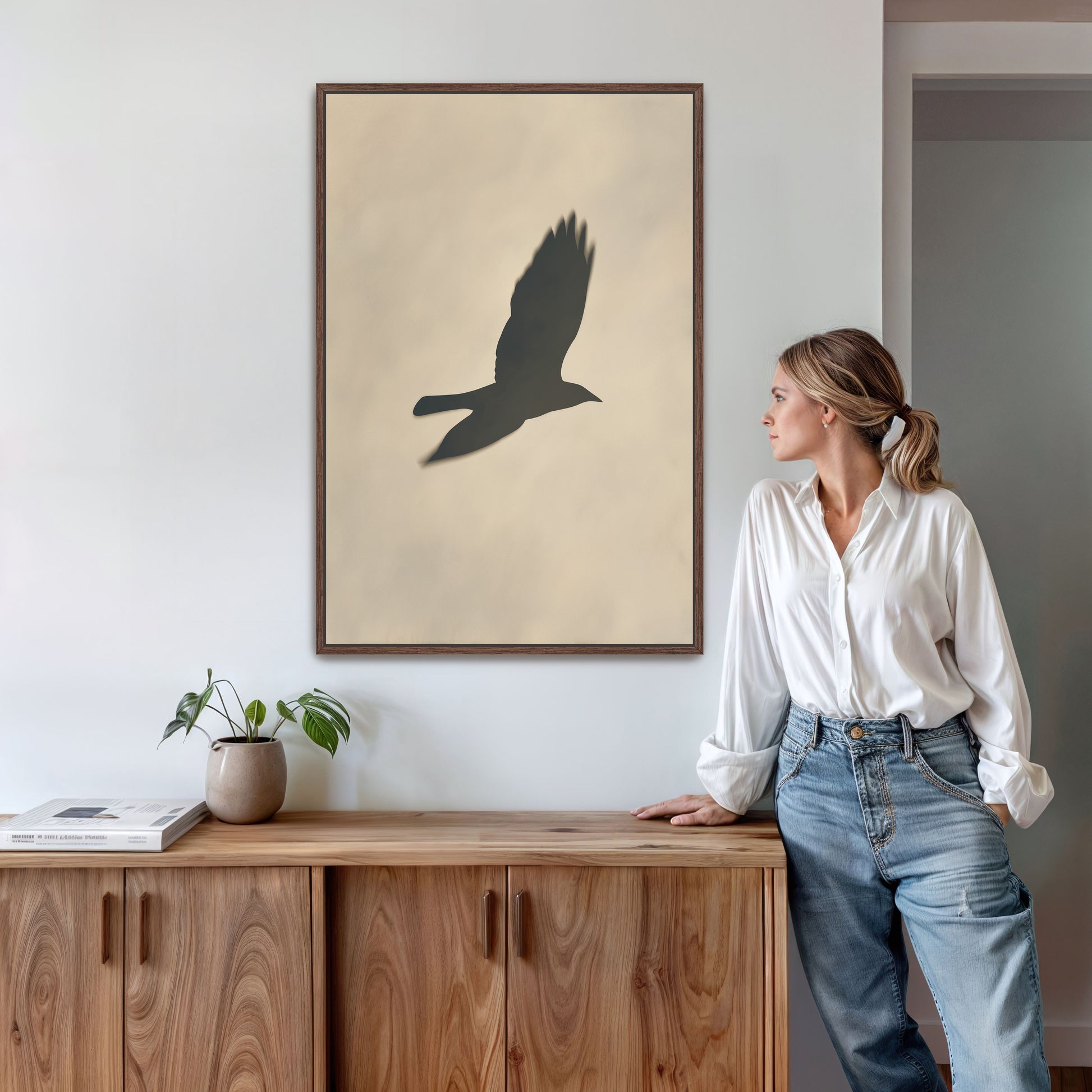 Soar canvas print featuring bird silhouette in soft neutral tones, framed and displayed in modern interior
