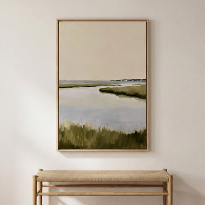a large painting of a serene landscape with a body of water and grassy terrain, hanging on a wall above a wooden bench.