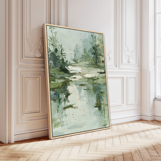 a large, framed painting of a serene landscape with a pond and trees, displayed on a white wall in a room with a wooden floor.