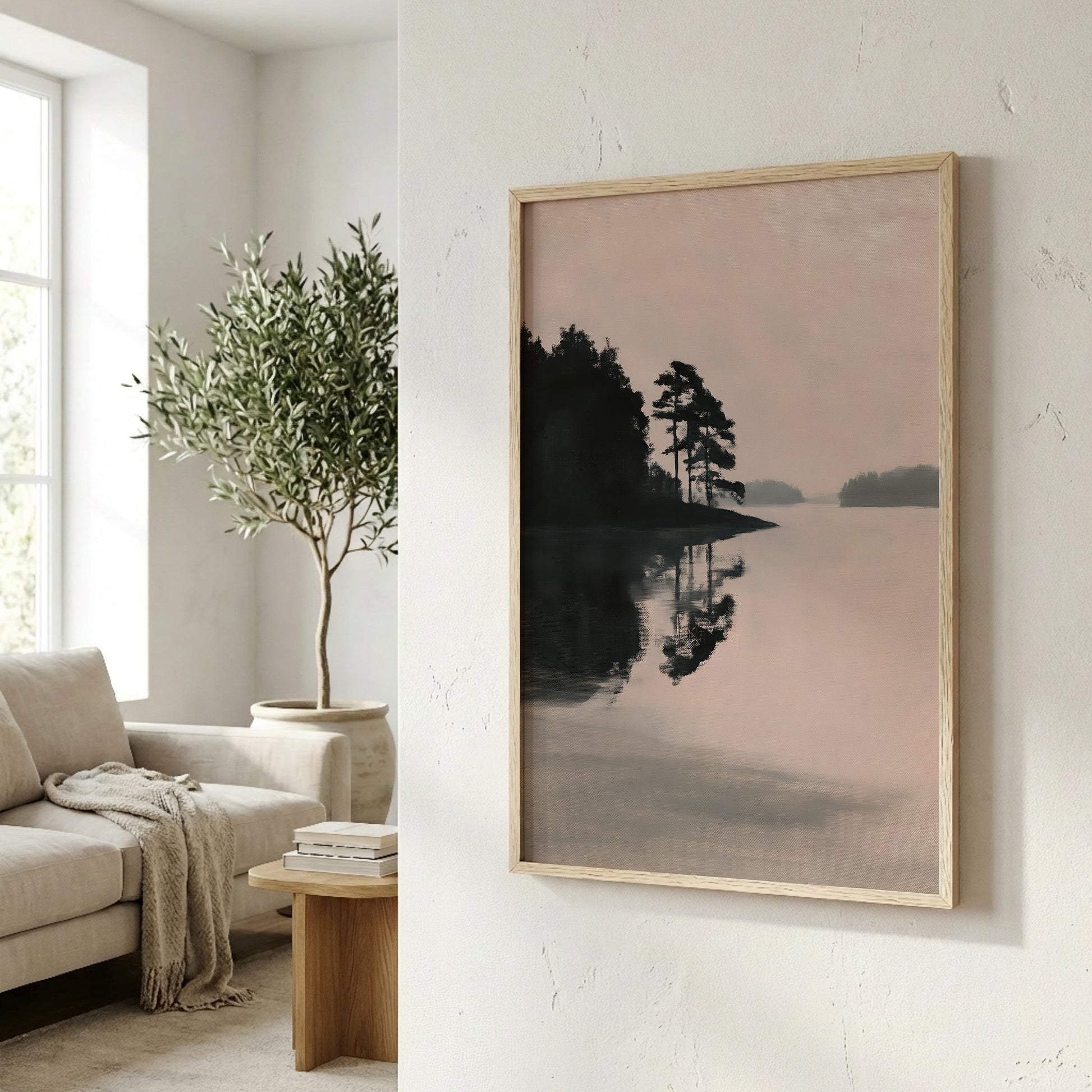 a serene indoor setting with a framed landscape painting hanging on the wall, depicting a tranquil lake scene with trees reflected in the water.