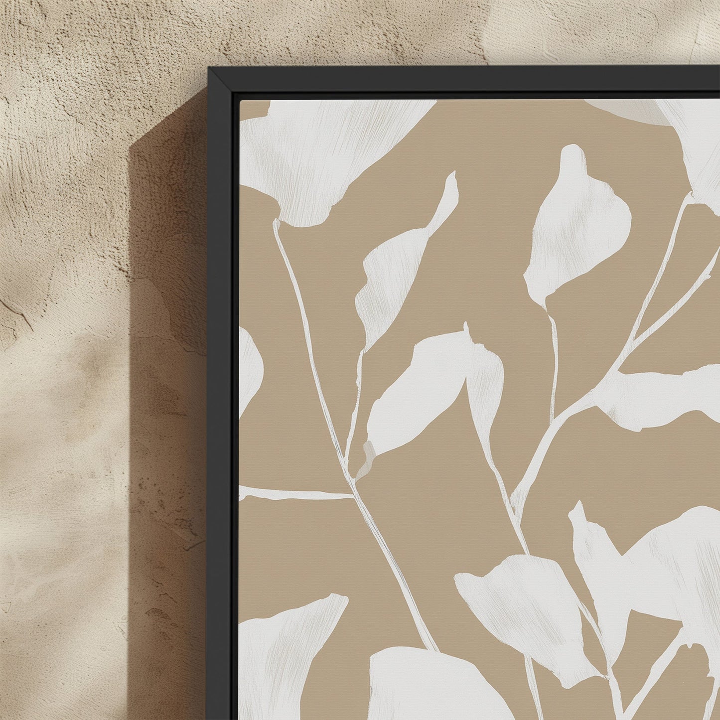 Driftleaf canvas print featuring soft white floral silhouettes on a beige background with a black frame, ideal for minimalist and coastal interiors.