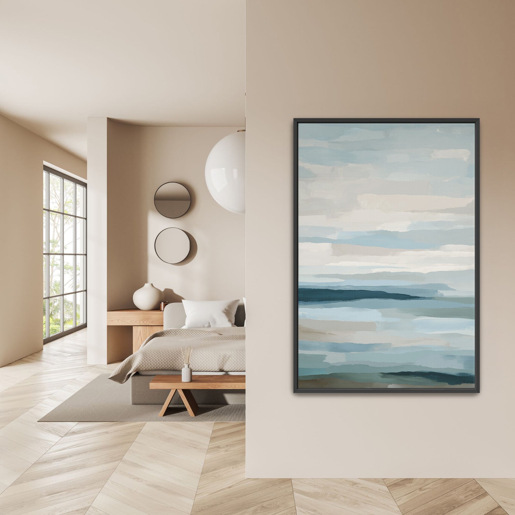 Lapse canvas print with soft blue, ivory, and sand tones depicting sea and sky, framed in black, displayed in modern bedroom.