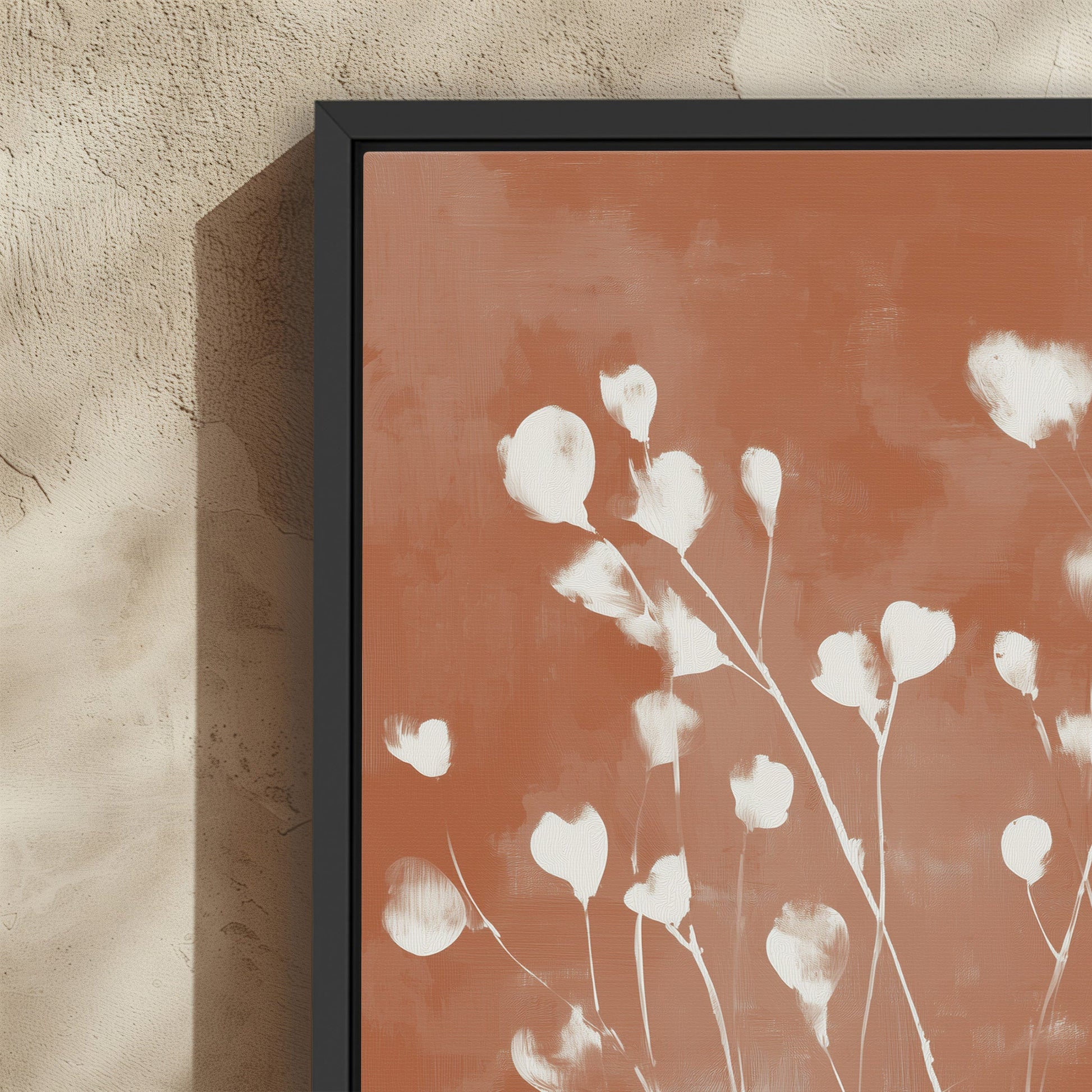 Ember Cavas Print with white petals on terracotta background in black frame