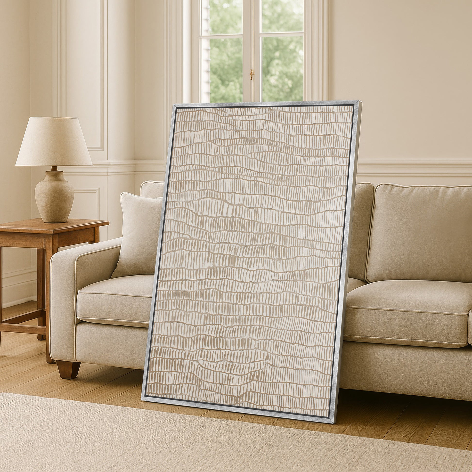 a large, rectangular, beige-colored artwork or painting displayed on a wall in a living room setting.