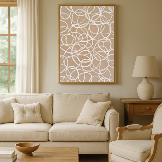 a cozy living room with a beige sofa, a wooden coffee table, and a framed abstract artwork on the wall.