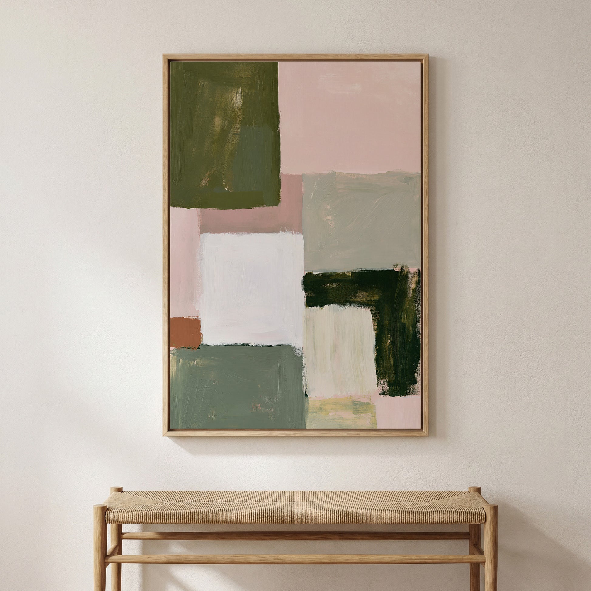 a large abstract painting hanging on a white wall above a wooden bench.