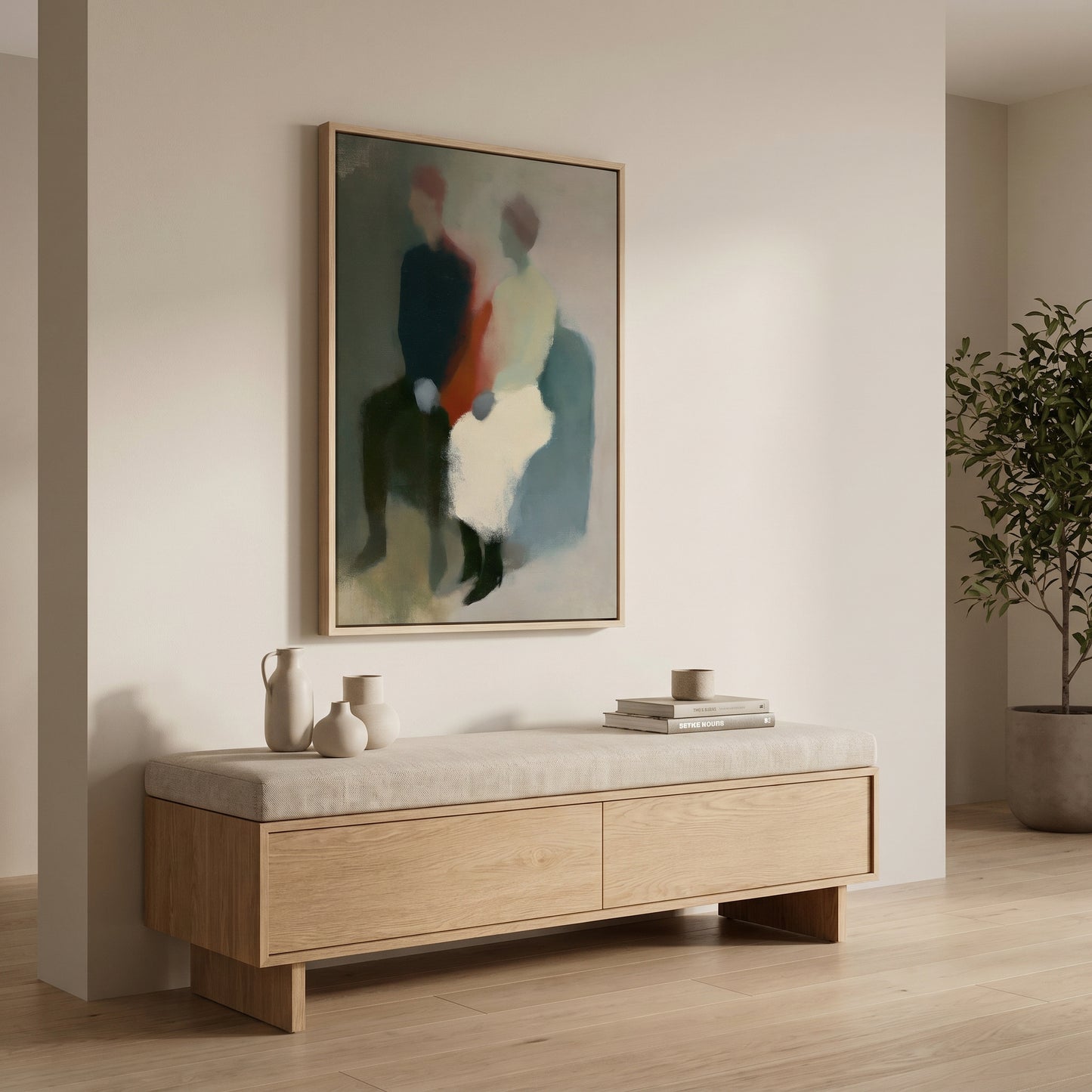 a minimalist interior design with a large abstract painting hanging on a white wall above a wooden bench with a white cushion. The painting depicts two people sitting together, and there are two white vases and a stack of books placed on the bench.